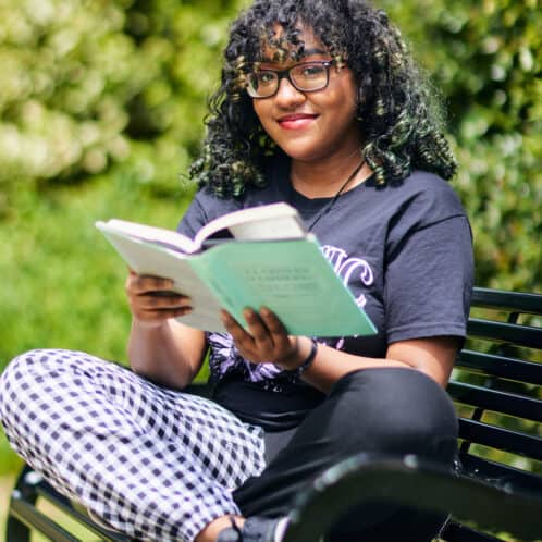 21 Student Portraits 202 female student reading outside